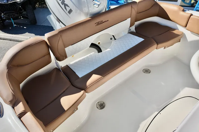 Slide: The Image of 2026 Pioneer 202 Islander boat interior with brown and white cushioned seating. - 12