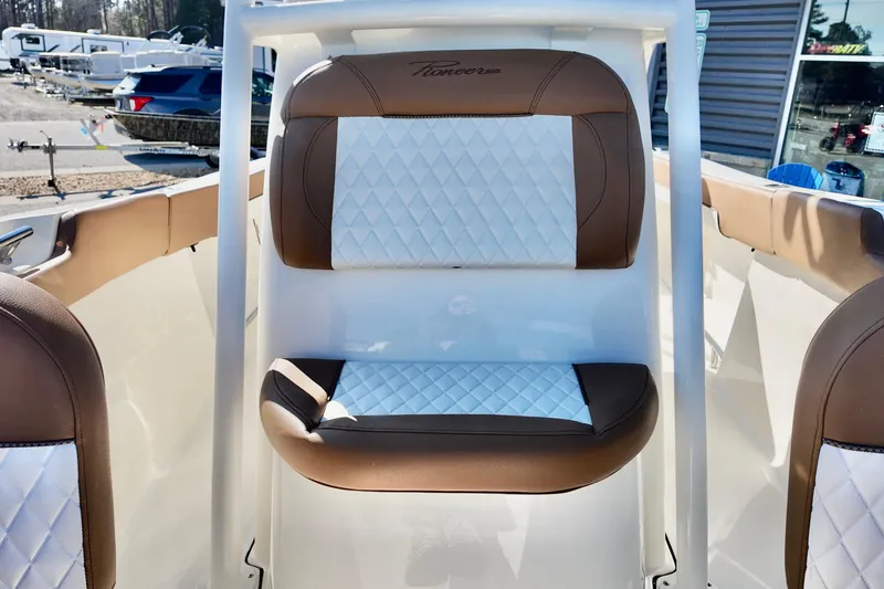 Slide: The Image of 2026 Pioneer 202 Islander boat interior with brown and white diamond-stitched seating. - 14