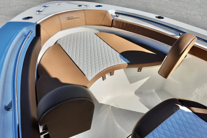 Slide: The Image of 2026 Pioneer 202 Islander boat interior with brown and gray seating. - 15
