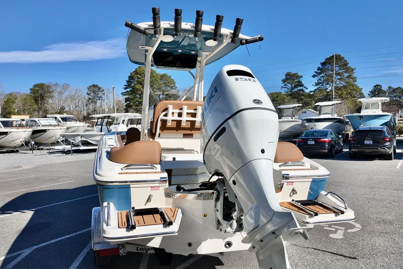 Slide: The Image of 2026 Pioneer 202 Islander boat with powerful outboard motor in a marina setting. - 18