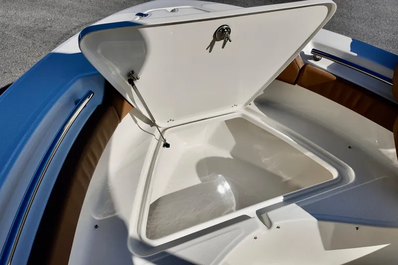 Slide: The Image of Open storage compartment on 2026 Pioneer 202 Islander boat, featuring sleek design and key lock. - 4