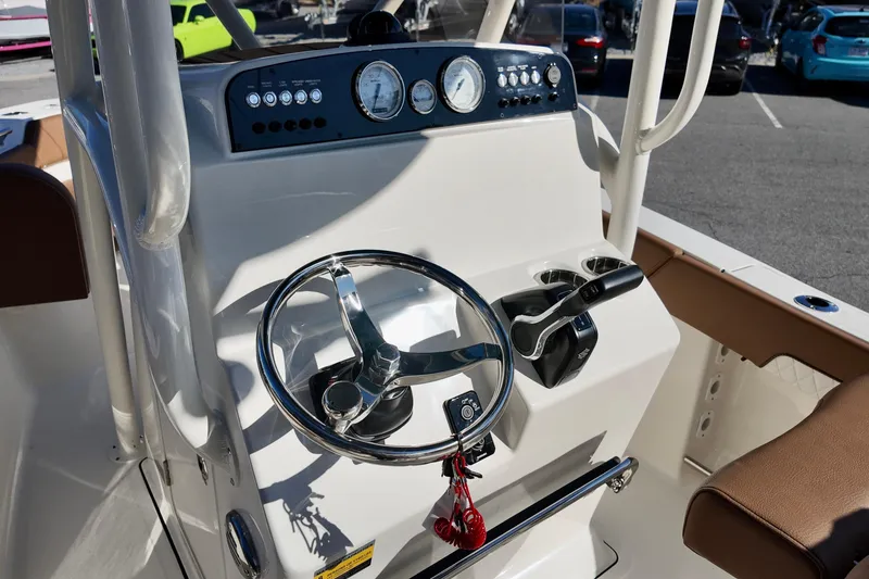 Slide: The Image of 2026 Pioneer 202 Islander boat dashboard with steering wheel and controls. - 9