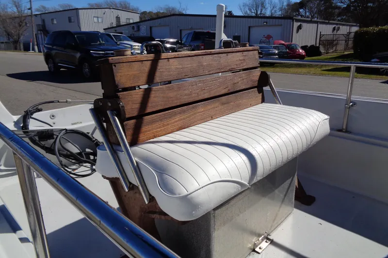 Slide: The Image of 1987 Boston Whaler Montauk 17' CC boat with wooden bench and white cushioned seat. - 13