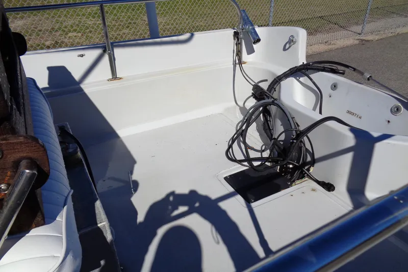 Slide: The Image of 1987 Boston Whaler Montauk 17' CC boat interior with cables and seating. - 18