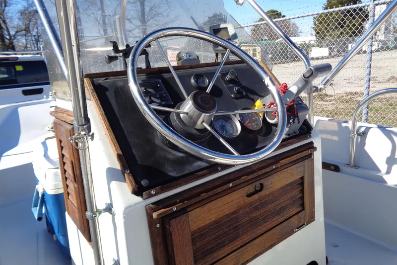 Slide: The Image of 1987 Boston Whaler Montauk 17' CC boat console with steering wheel and gauges. - 19