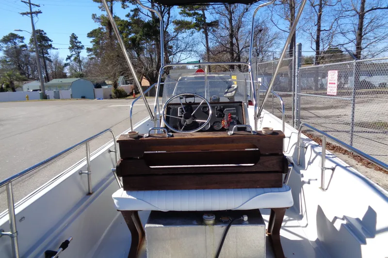 Slide: The Image of 1987 Boston Whaler Montauk 17' CC boat interior with steering console and seating. - 5