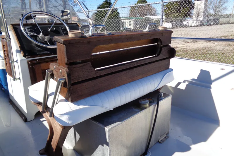 Slide: The Image of 1987 Boston Whaler Montauk 17' CC boat interior with wooden console and steering wheel. - 7
