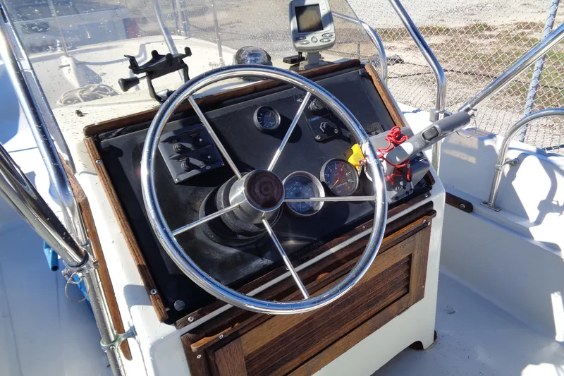 Slide: The Image of 1987 Boston Whaler Montauk 17' CC boat console with steering wheel and gauges. - 8