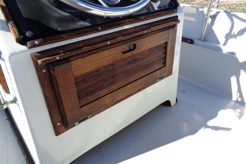 Slide: The Image of 1987 Boston Whaler Montauk 17' CC console with wooden storage compartment. - 9