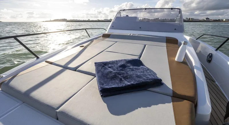Slide: The Image of Beneteau Flyer 9 SUNdeck 2023 on water with towel and bottle. - 10