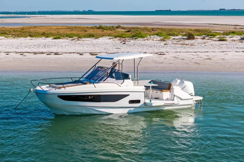 Slide: The Image of 2023 Beneteau Flyer 9 SUNdeck boat anchored near a sandy beach. - 28