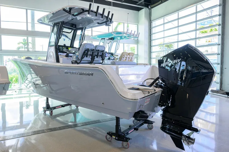 The Image of 2026 Sportsman Open 232 Center Console boat with Mercury engine in showroom. - 0