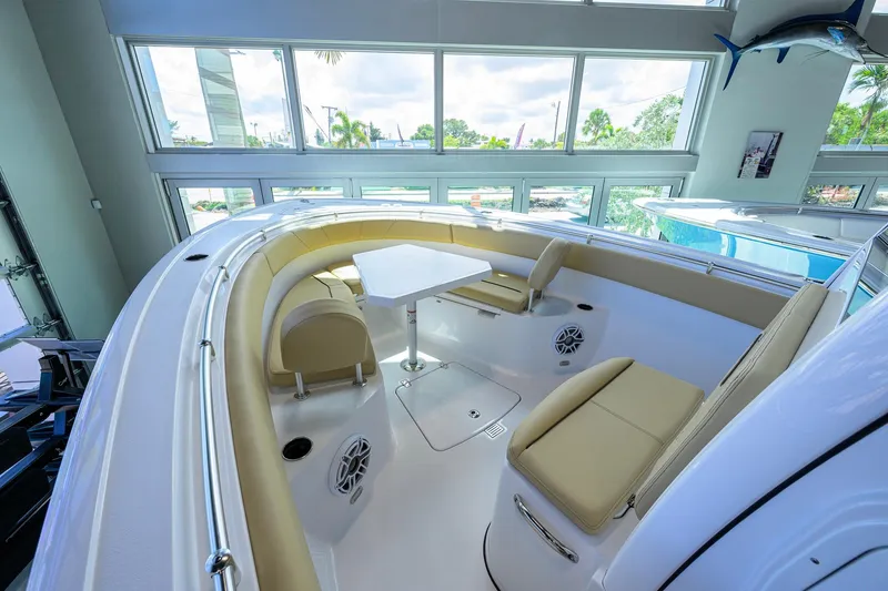 Slide: The Image of 2026 Sportsman Open 232 Center Console boat interior with seating and table. - 10