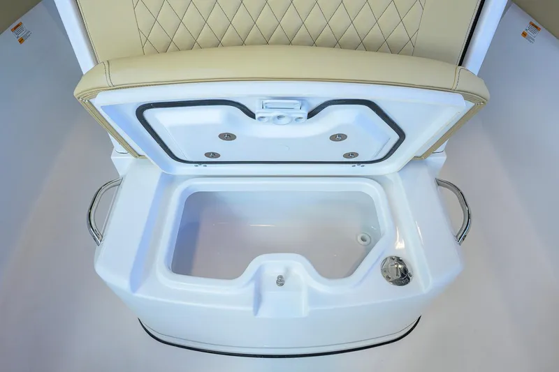 Slide: The Image of 2026 Sportsman Open 232 Center Console boat's open storage compartment with cushioned seat. - 18