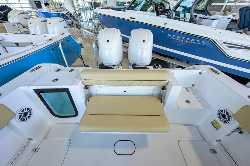 Slide: The Image of 2026 Sportsman Open 232 Center Console boat interior with seating and dual engines. - 27