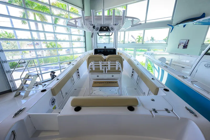 Slide: The Image of 2026 Sportsman Open 232 Center Console boat in showroom, featuring spacious seating and modern design. - 30