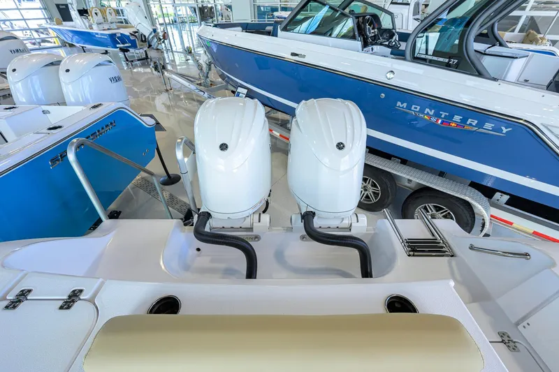 Slide: The Image of 2026 Sportsman Open 232 Center Console boat with dual engines in showroom. - 34