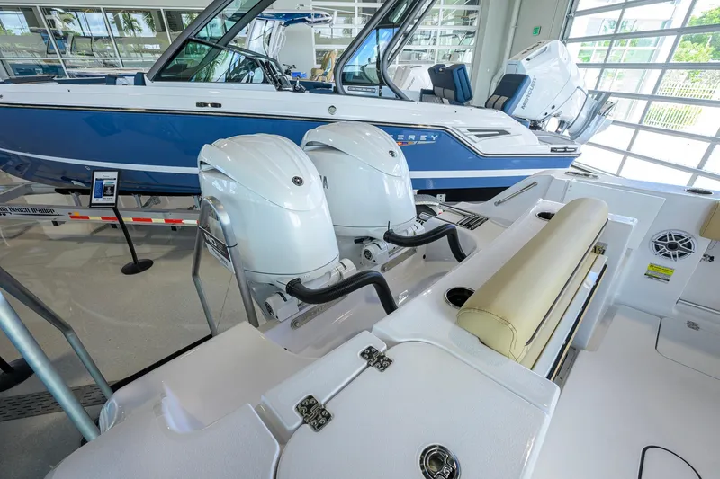 Slide: The Image of 2026 Sportsman Open 232 Center Console boat with dual outboard engines in showroom. - 35