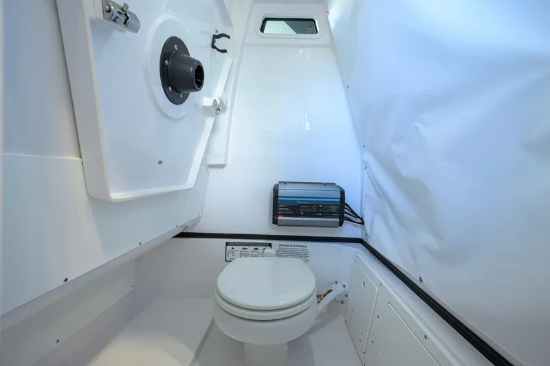Slide: The Image of Interior of 2026 Sportsman Open 232 Center Console boat with marine toilet. - 43