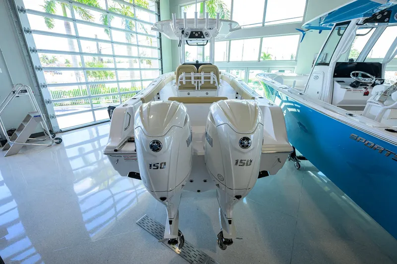 Slide: The Image of 2026 Sportsman Open 232 Center Console boat with dual Yamaha 150 engines in showroom. - 49