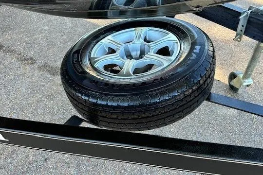 Slide: The Image of Spare tire mounted on a 2017 Ranger Z185 trailer, parked on asphalt. - 9
