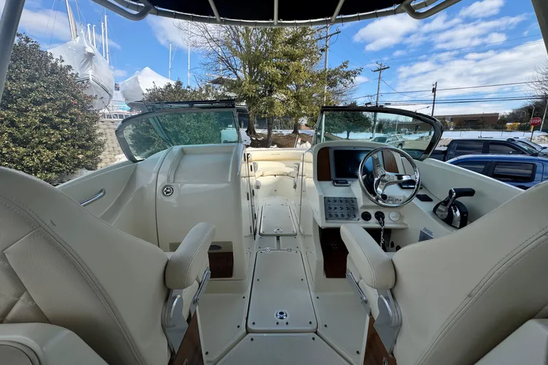 Slide: The Image of 2017 Chris-Craft Calypso 26 boat interior with steering wheel and seating. - 10