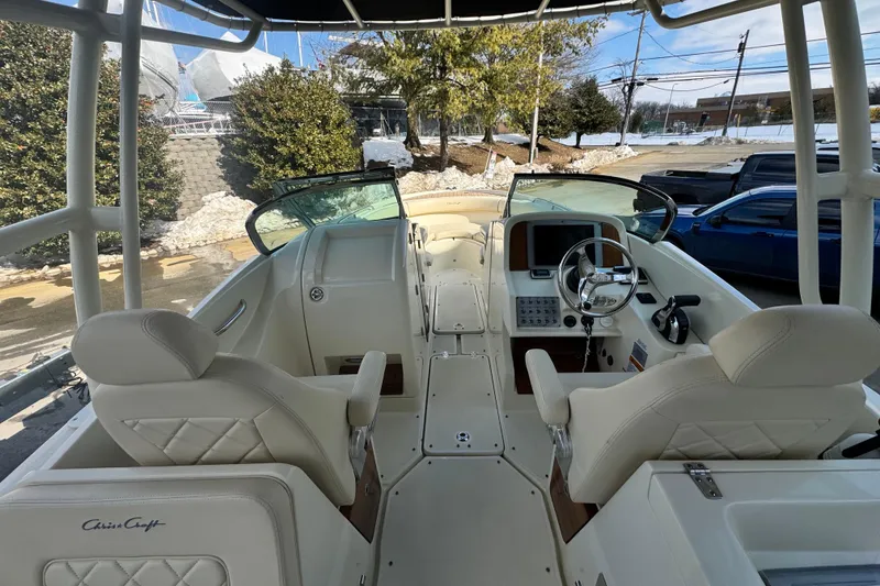 Slide: The Image of 2017 Chris-Craft Calypso 26 boat interior with dual seats and steering console. - 11