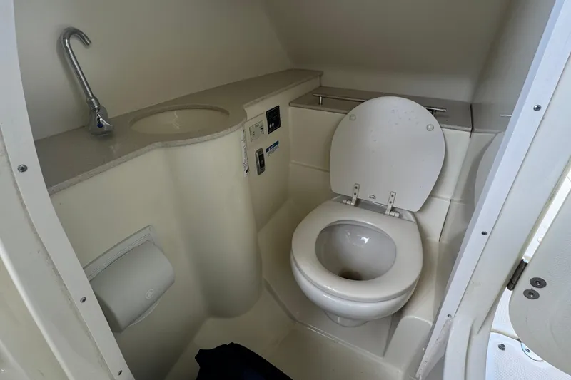 Slide: The Image of 2017 Chris-Craft Calypso 26 boat bathroom with toilet and sink. - 17
