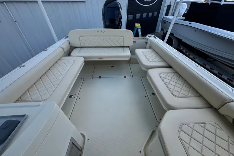Slide: The Image of 2017 Chris-Craft Calypso 26 boat interior with cream diamond-stitched seating. - 18