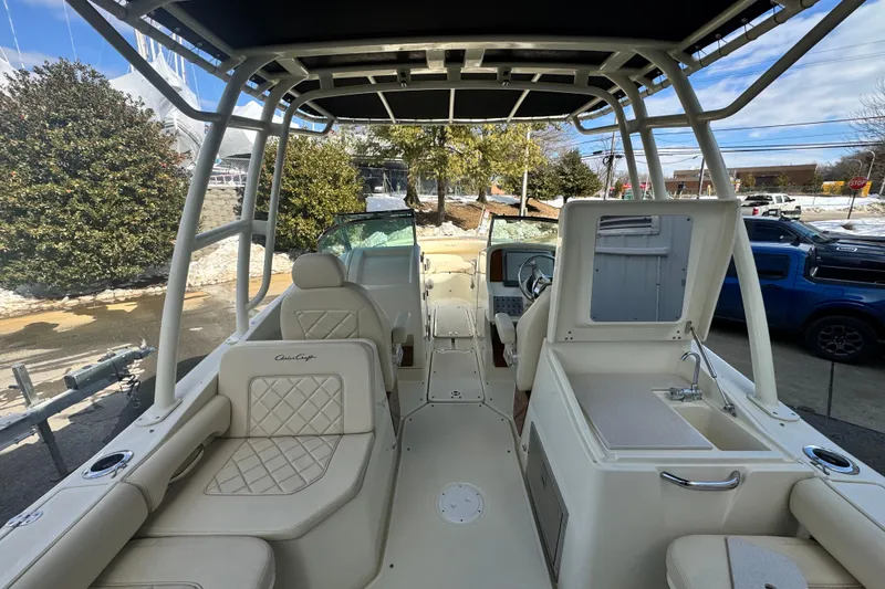 Slide: The Image of 2017 Chris-Craft Calypso 26 boat interior with seating, sink, and steering console. - 20
