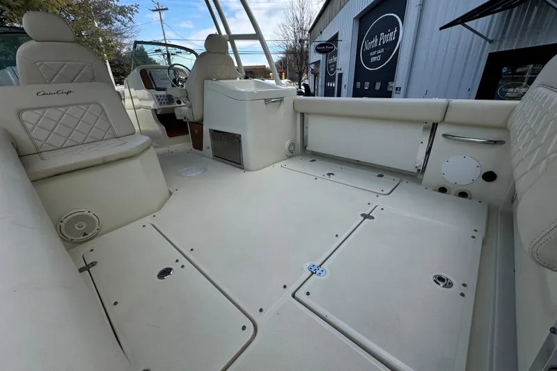Slide: The Image of 2017 Chris-Craft Calypso 26 boat interior with beige seating and spacious deck. - 22