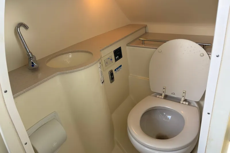 Slide: The Image of 2017 Chris-Craft Calypso 26 boat bathroom with sink and toilet. - 24