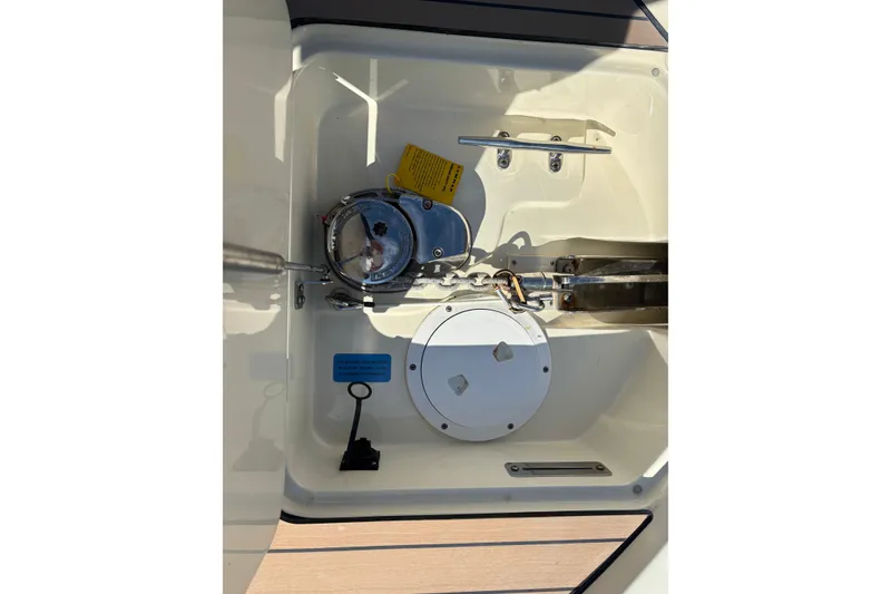 Slide: The Image of 2017 Chris-Craft Calypso 26 boat anchor compartment with winch and chain. - 35
