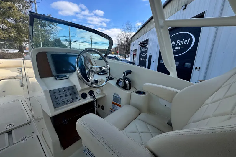 Slide: The Image of 2017 Chris-Craft Calypso 26 boat interior with steering wheel and control panel. - 9