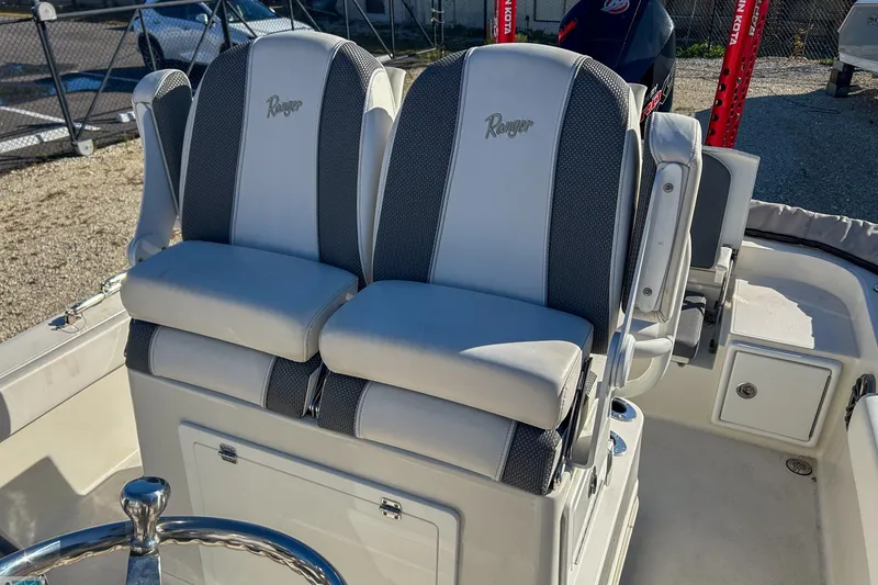 Slide: The Image of 2022 Ranger 2360 Bay boat seats with gray and white upholstery. - 14