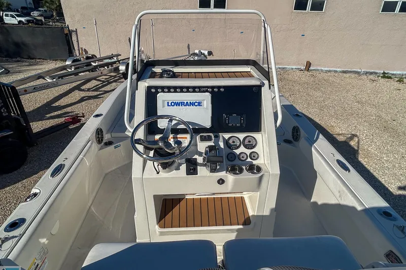 Slide: The Image of 2022 Ranger 2360 Bay boat console with steering wheel and navigation equipment. - 7