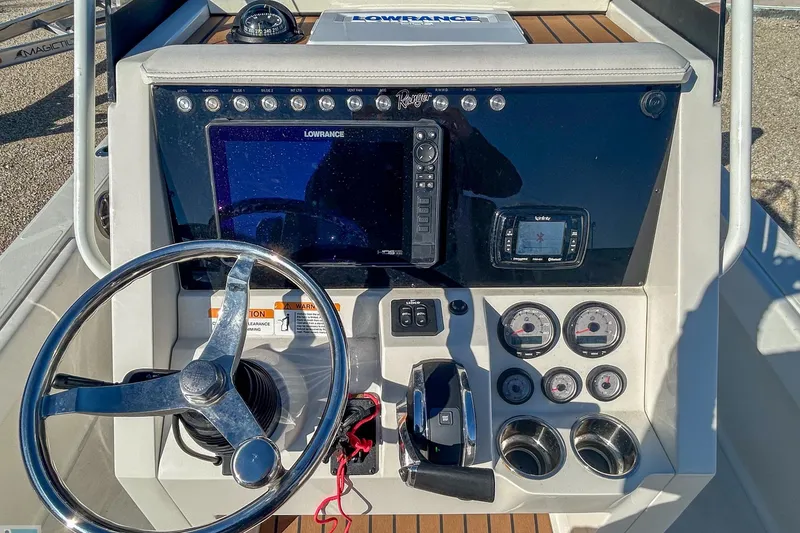 Slide: The Image of 2022 Ranger 2360 Bay boat dashboard with steering wheel and navigation instruments. - 9