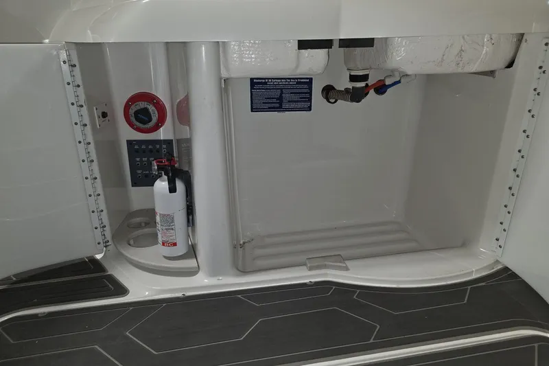 Slide: The Image of 2000 Formula 330 Sun Sport interior compartment with fire extinguisher and control panel. - 10