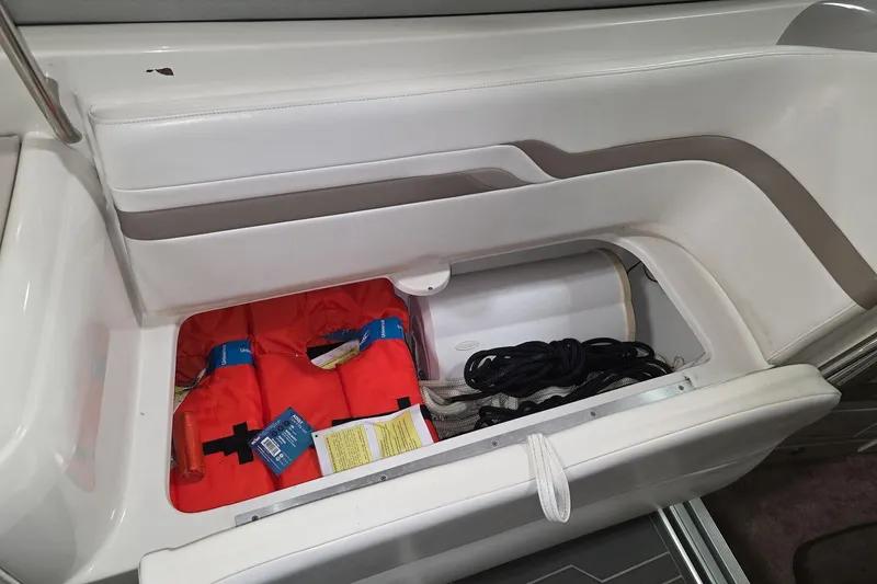 Slide: The Image of Storage compartment in a 2000 Formula 330 Sun Sport boat with life jackets and ropes. - 11