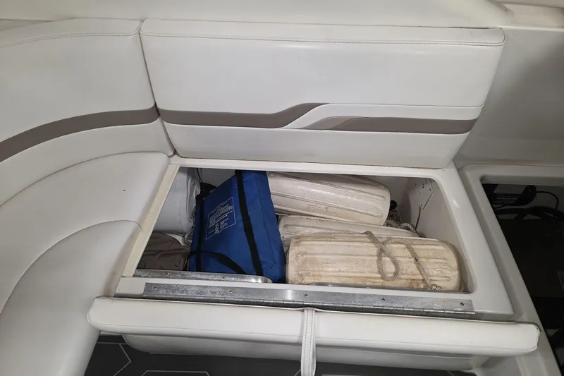 Slide: The Image of Storage compartment in a 2000 Formula 330 Sun Sport boat with life jackets and equipment. - 12
