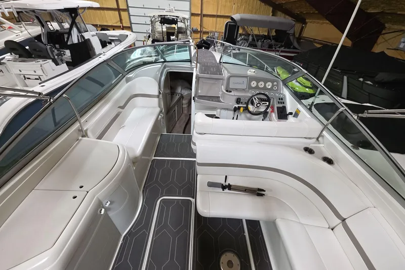 Slide: The Image of 2000 Formula 330 Sun Sport boat interior with seating and control panel in a showroom. - 18