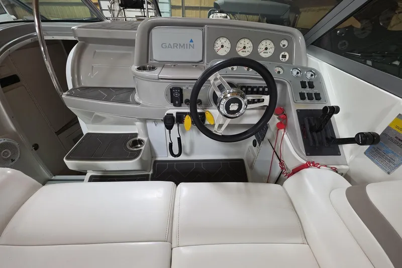 Slide: The Image of 2000 Formula 330 Sun Sport boat cockpit with Garmin navigation and modern controls. - 19