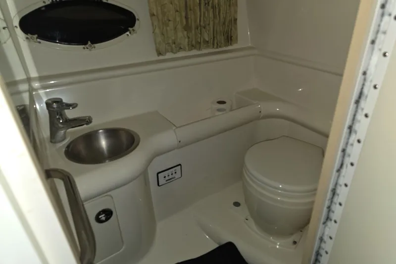 Slide: The Image of Compact bathroom in 2000 Formula 330 Sun Sport boat with sink and toilet. - 5