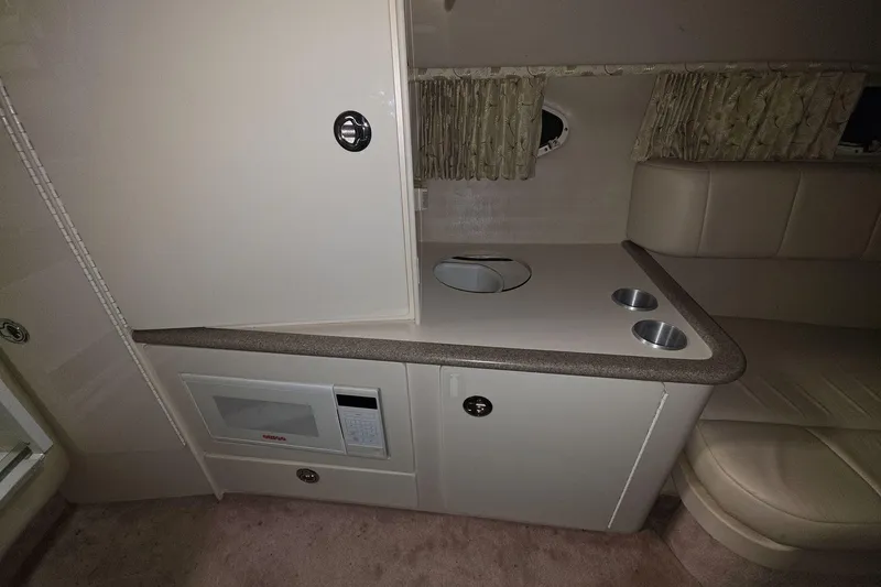 Slide: The Image of Interior of 2000 Formula 330 Sun Sport boat with kitchenette and seating area. - 8