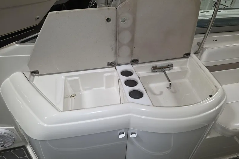 Slide: The Image of Wet bar on a 2000 Formula 330 Sun Sport boat with sink and cup holders. - 9