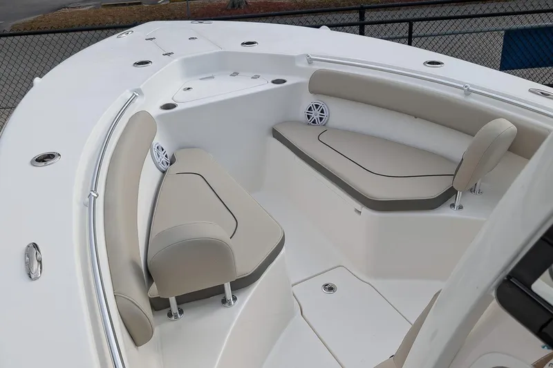 Slide: The Image of 2026 Key West 244 Center Console boat interior with beige seating and speakers. - 17