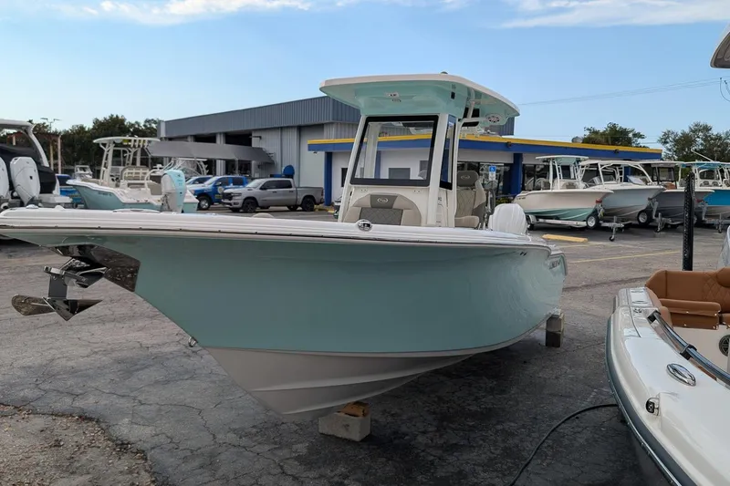 Slide: The Image of 2026 Key West 244 Center Console boat displayed at a dealership lot. - 2