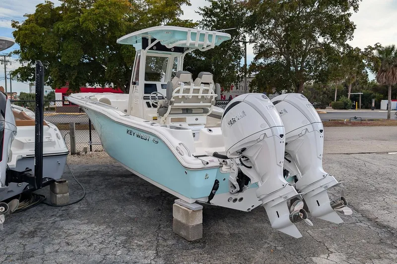 Slide: The Image of 2026 Key West 244 Center Console boat with dual Yamaha engines, parked outdoors. - 3