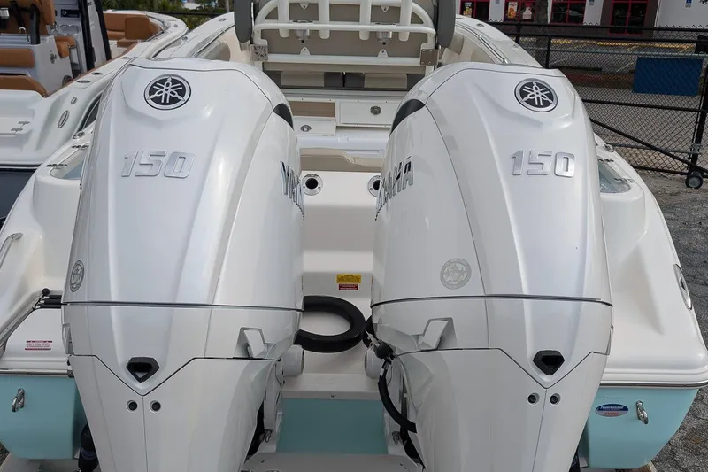 Slide: The Image of 2026 Key West 244 Center Console with dual Yamaha 150 engines, rear view. - 5