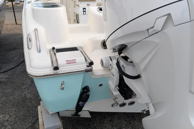 Slide: The Image of 2026 Key West 244 Center Console boat with outboard motor and swim ladder. - 6